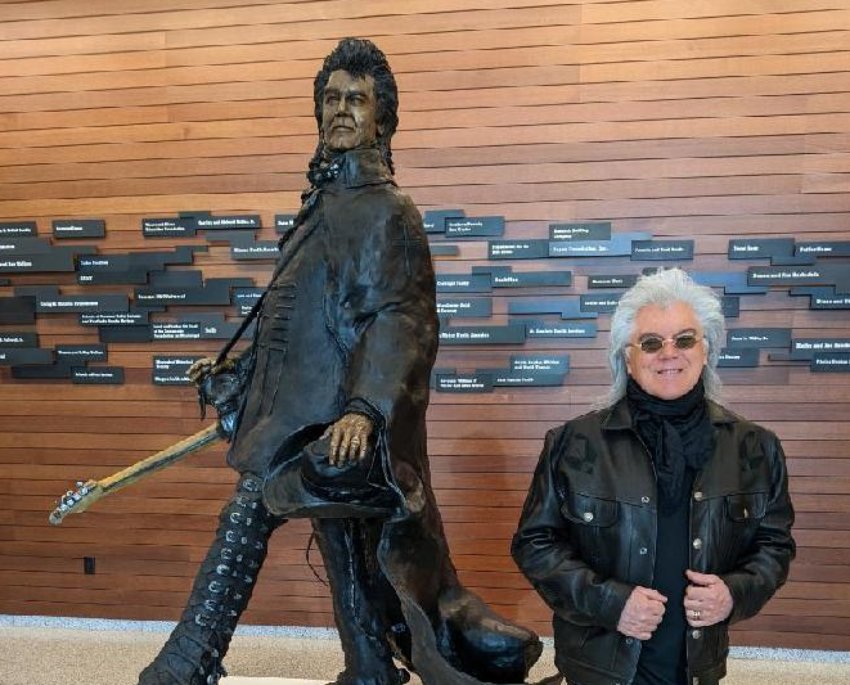 Marty Stuart stands in front of a statue in his honor unveiled on Friday in Jackson.